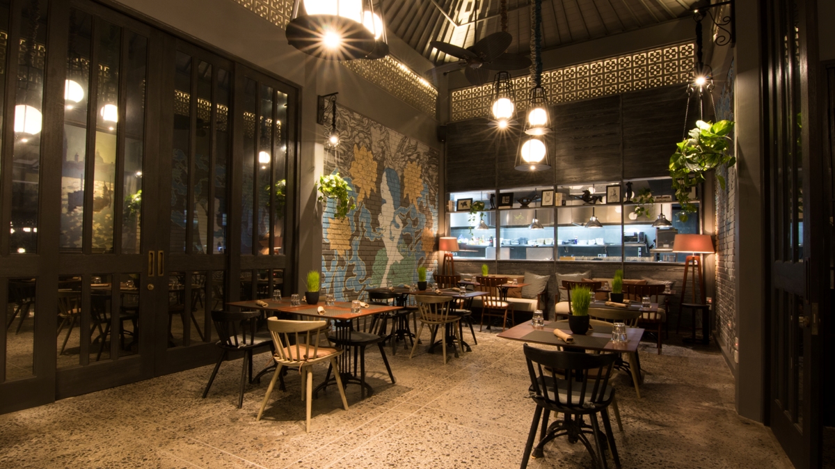 Refined colonial-inspired indoor dining room with natural wood finishes